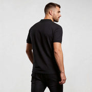 Alt Tag: Core Polo Shirt CO001 polo shirt by MEXESS in black, back view of men’s organic cotton short-sleeve polo