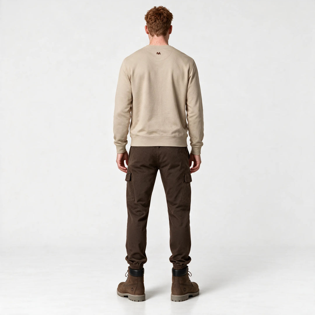 Full-length back view of the beige sweatshirt styled with brown cargo pants