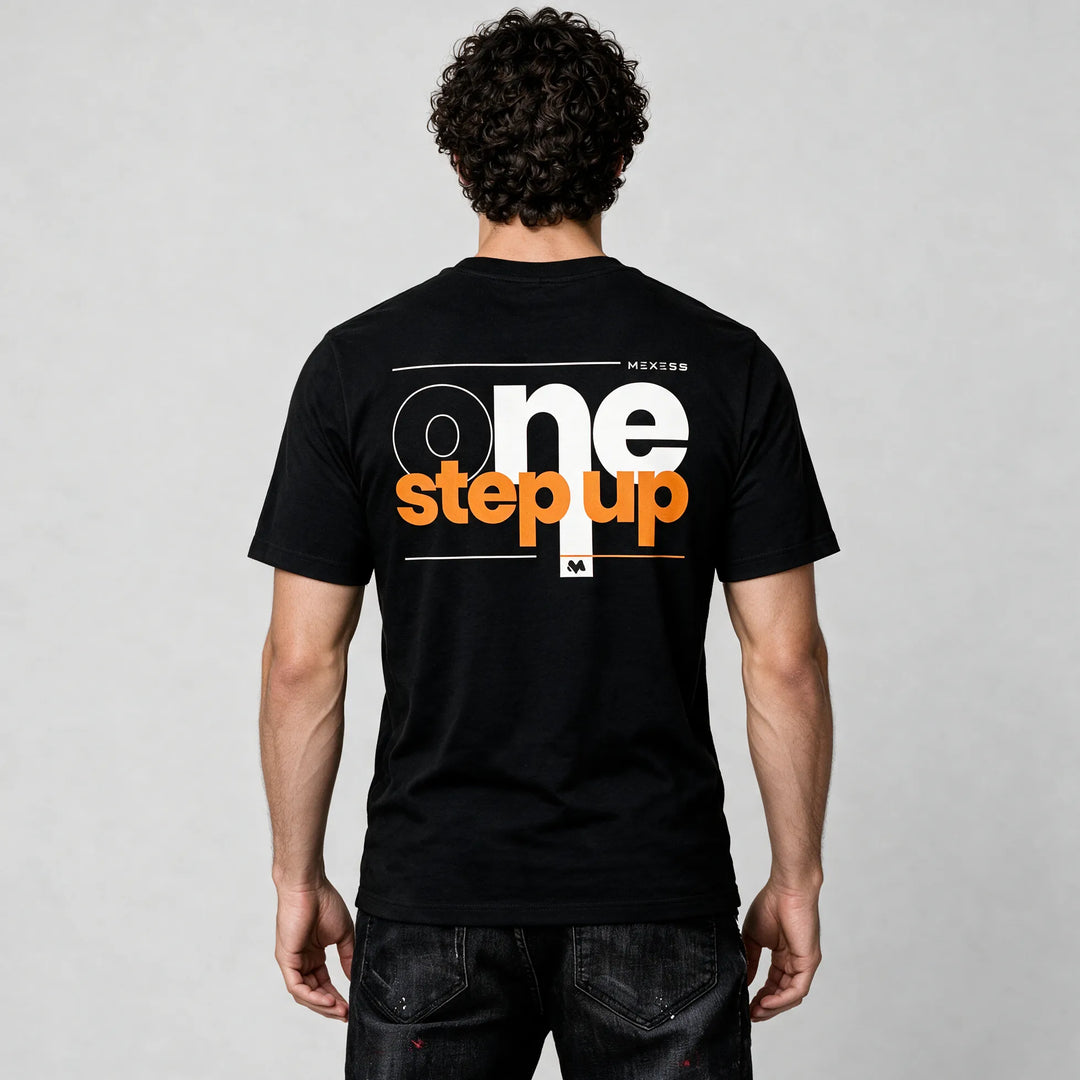 Back of the black organic cotton t-shirt with large one step up lettering in white and orange