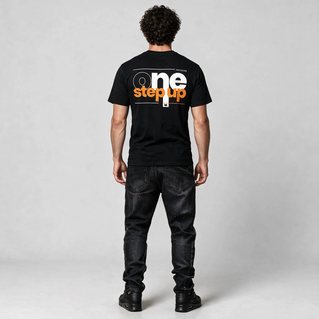 Full-length back view of the black t-shirt with the one step up print