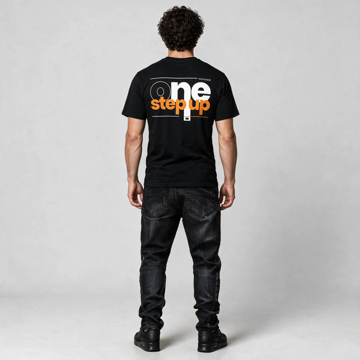 Full-length back view of the black t-shirt with the one step up print