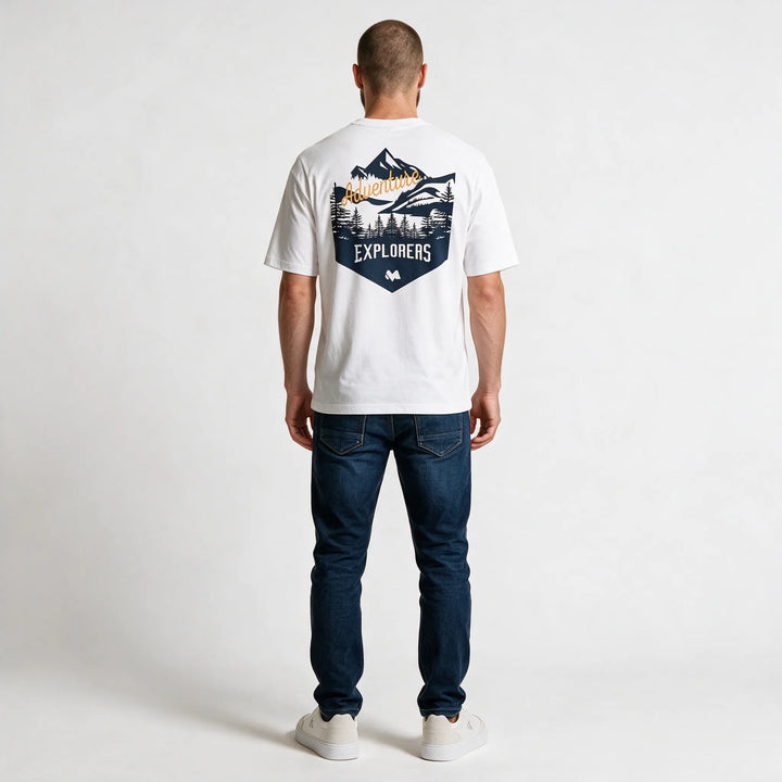 Full-length back view of the white t-shirt with the navy EXPLORERS badge