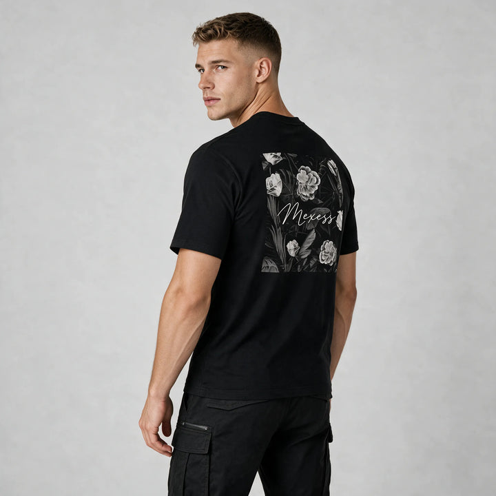 Flower shirt for men in black with a grey rose and leaf back print, seen from the back at an angle