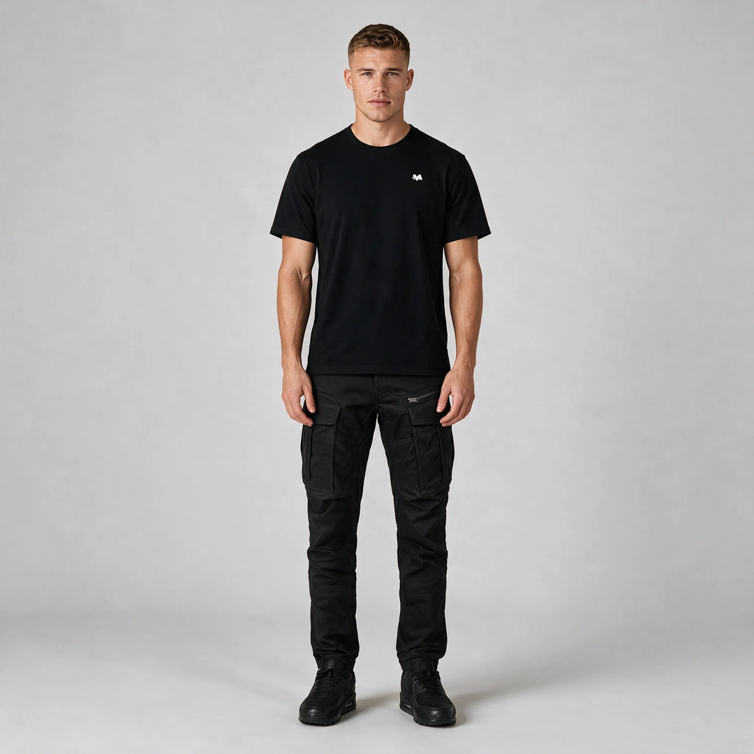 Full-length front view of the black crew neck t-shirt with a small white M logo on the chest