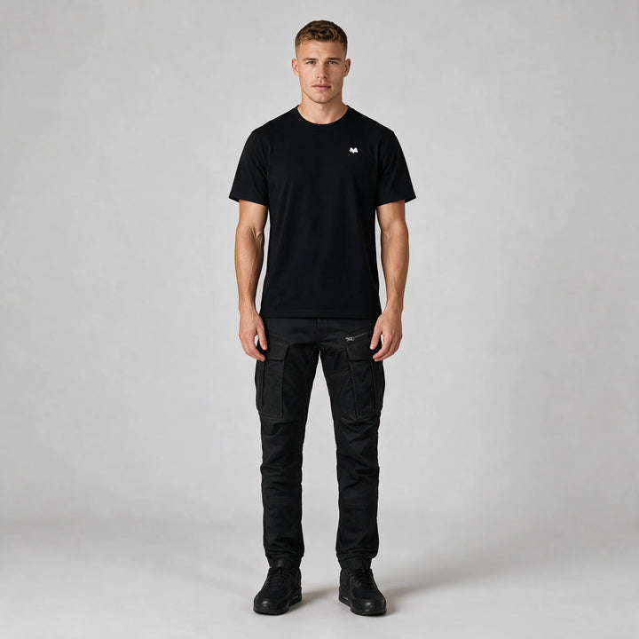Full-length front view of the black crew neck t-shirt with a small white M logo on the chest