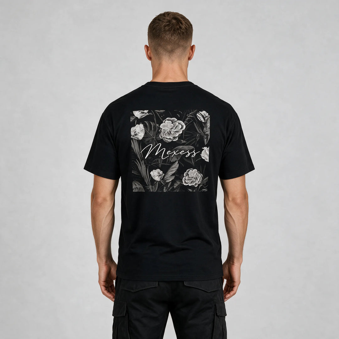 Back view of the black t-shirt with a framed black-and-white floral print and MEXESS script