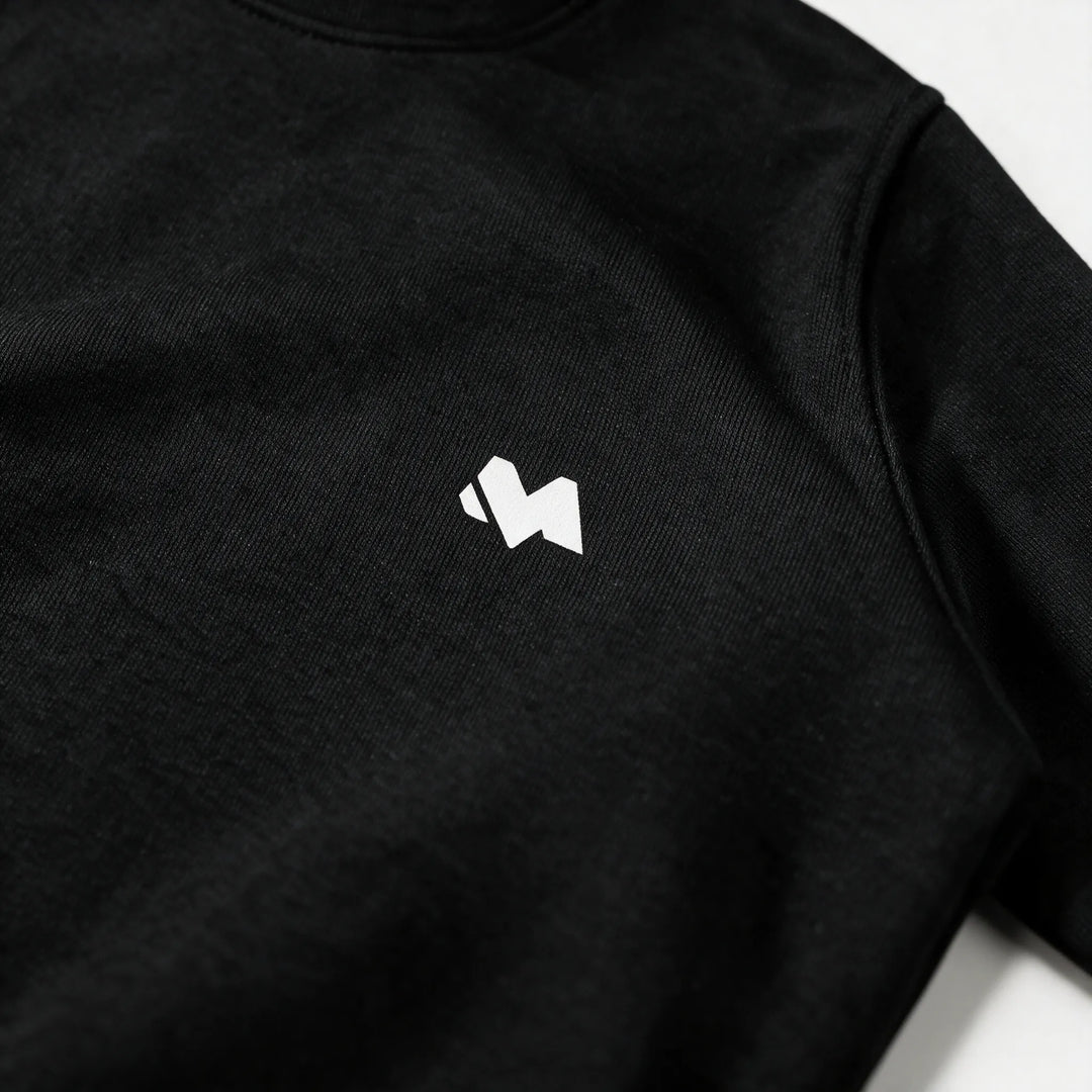 Close-up of the white M logo print on the left chest of the black sweatshirt
