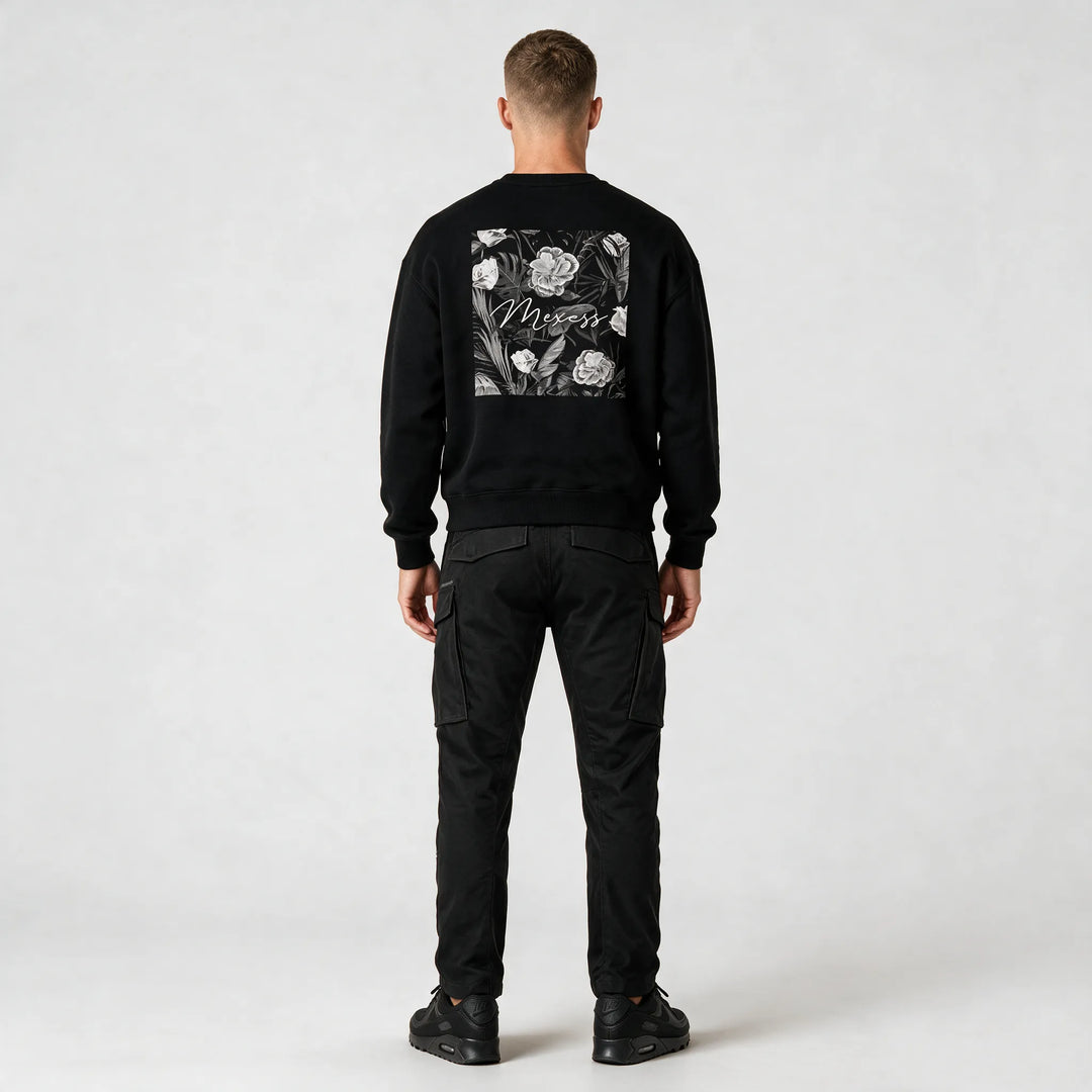 Full-length back view of a model wearing the sweatshirt with black cargo pants