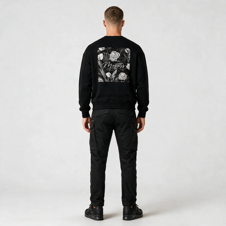 Full-length back view of a model wearing the sweatshirt with black cargo pants