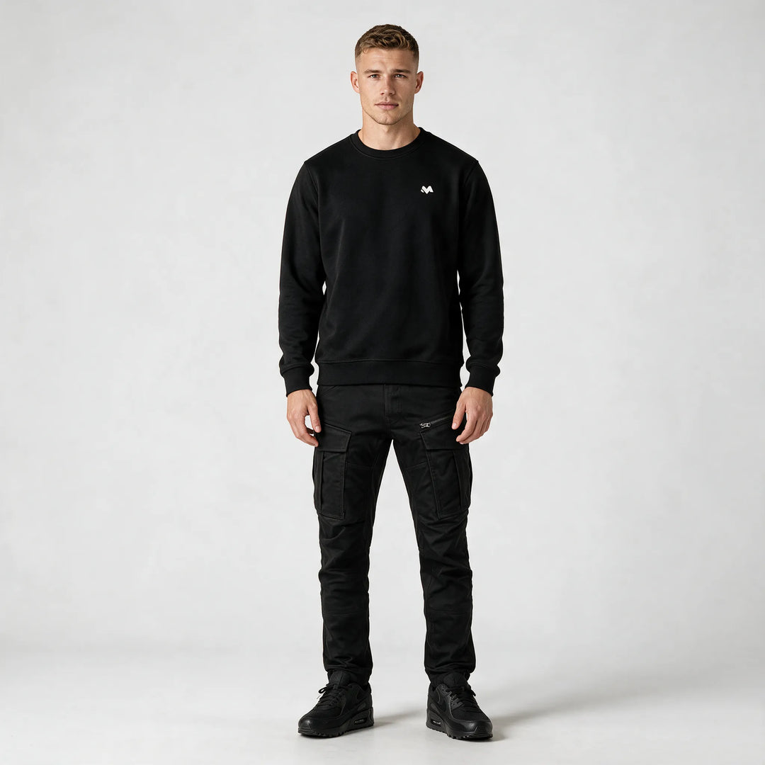 Full-length front view of the black crewneck sweatshirt worn with black cargo pants