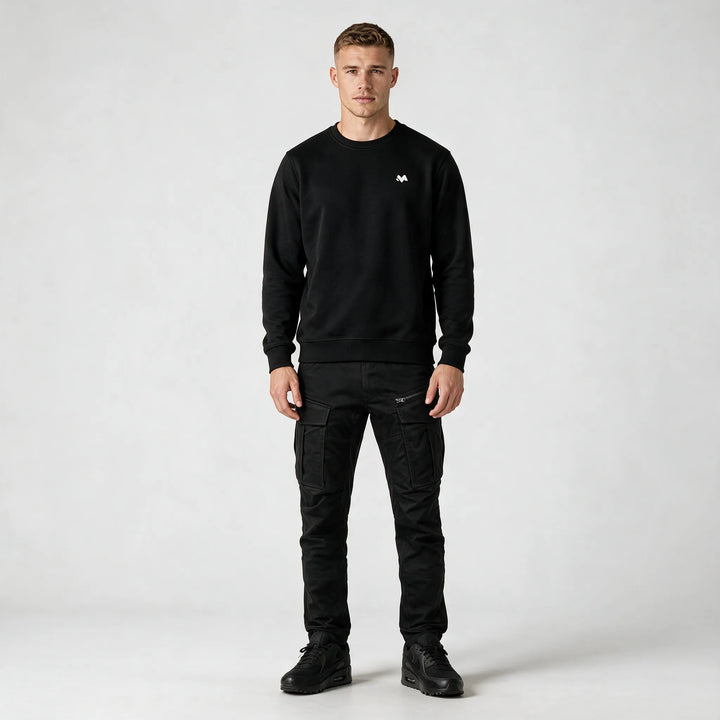 Full-length front view of the black crewneck sweatshirt worn with black cargo pants