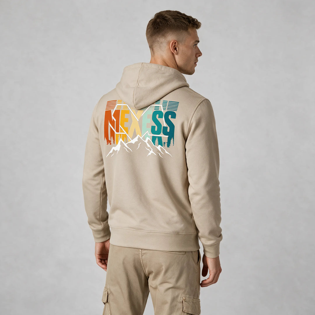 Beige organic cotton pullover hoodie with a retro MEXESS mountain back print, worn by a man, rear three-quarter view