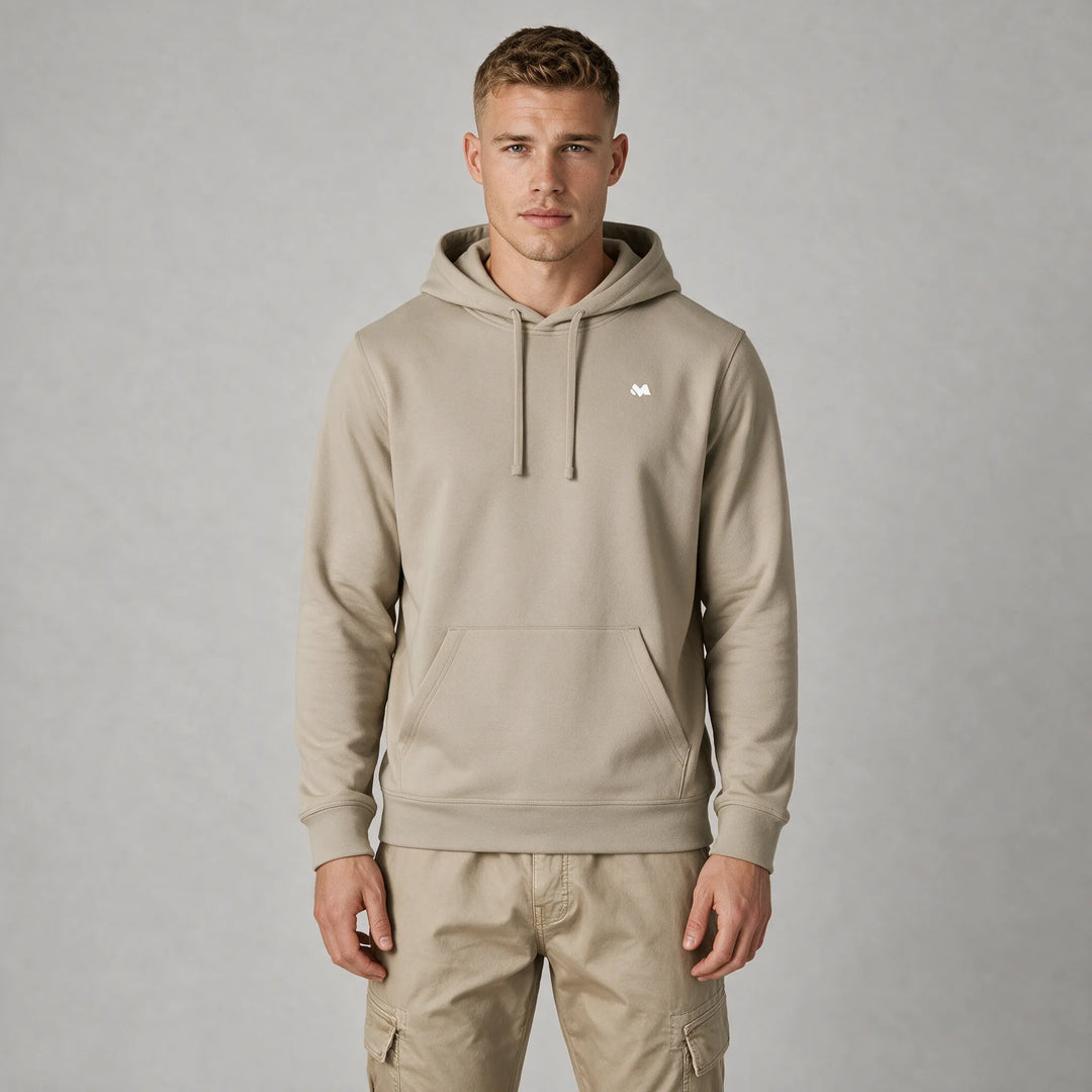 Front view of a man in a beige hoodie with a small white MEXESS logo on the left chest