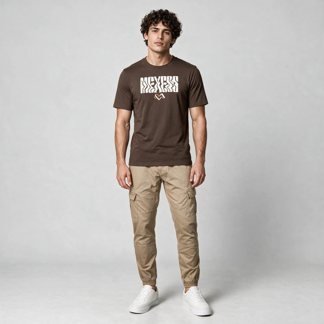 Full-length front view of a mocha brown graphic t-shirt worn with beige cargo pants and white sneakers