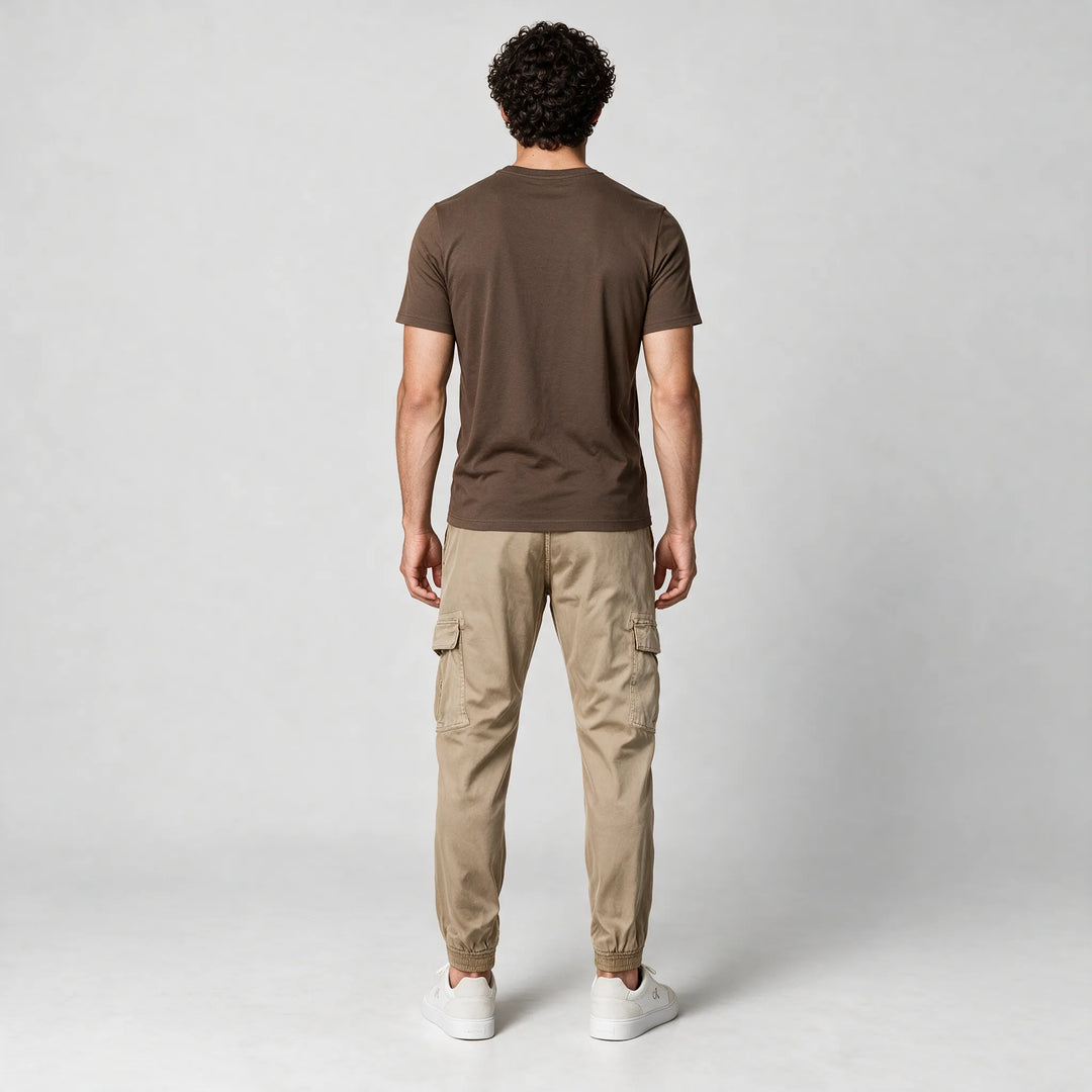 Full-length back view of a mocha brown t-shirt worn with beige cargo pants and white sneakers