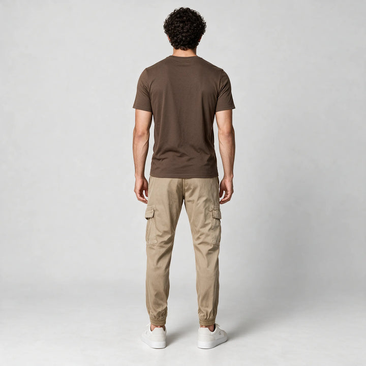 Full-length back view of a mocha brown t-shirt worn with beige cargo pants and white sneakers
