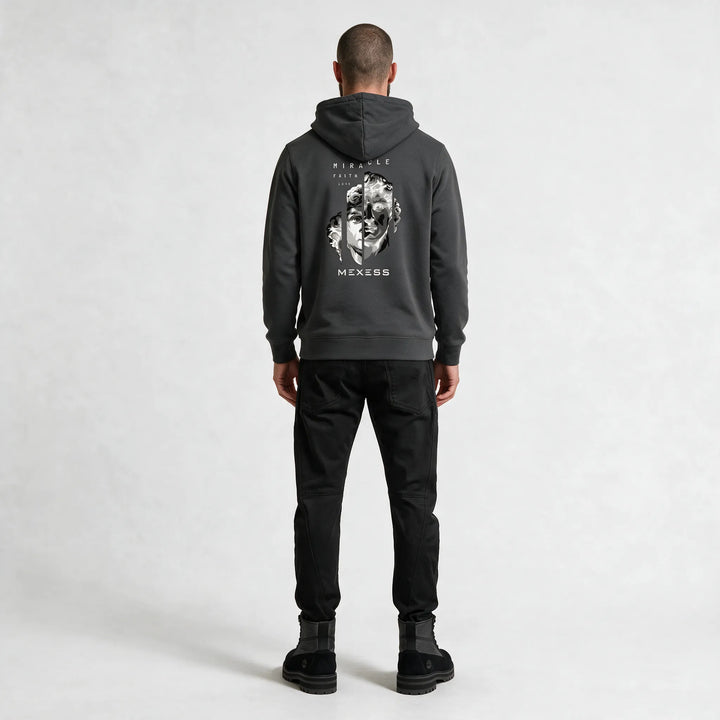 Full-length back view of the dark gray hoodie with the statue print