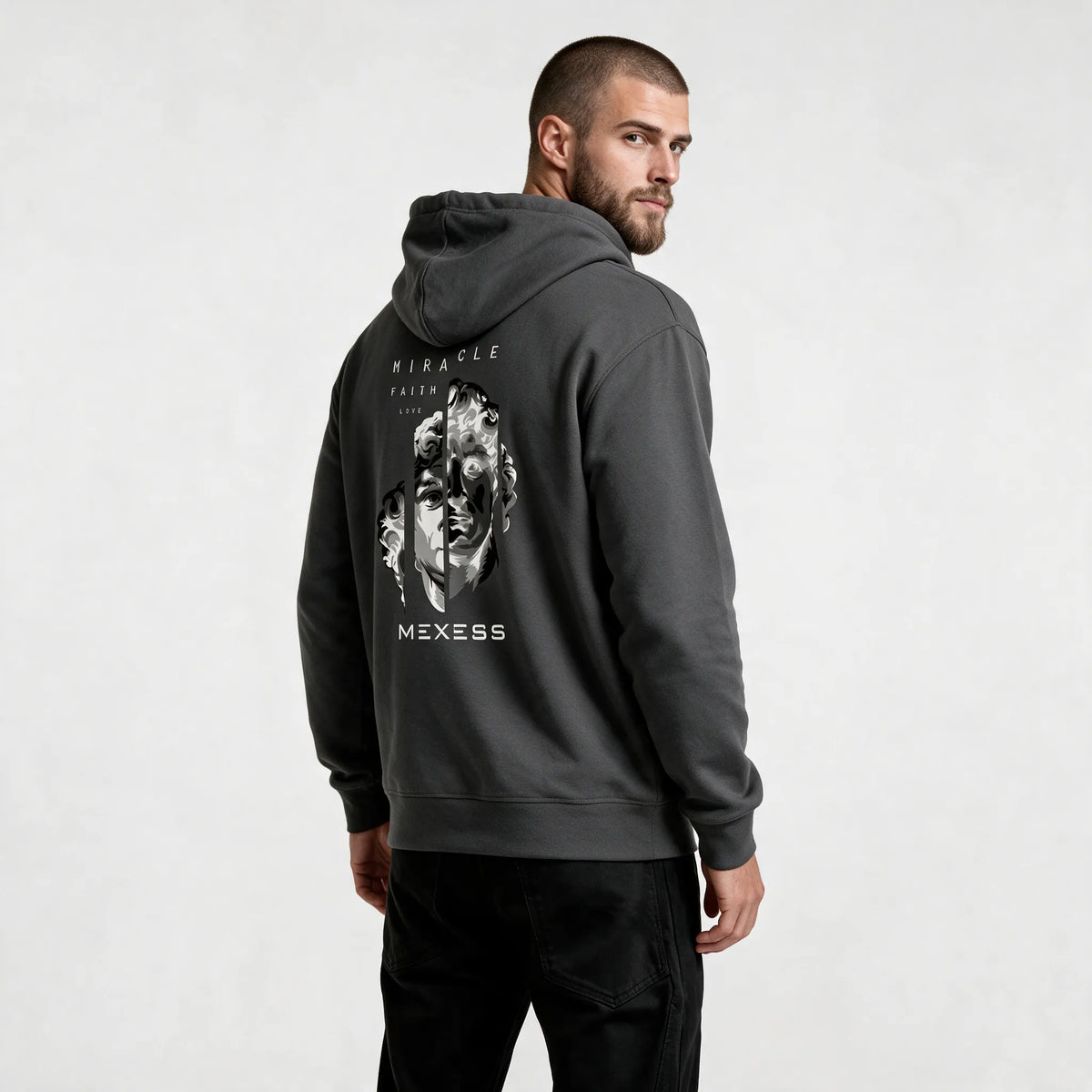 Side-back view of the dark gray hoodie with Miracle, Faith, Love text