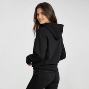 Woman wearing Iconic Streetwear Hoodie DR667 by MEXESS in black, showcasing minimalist design and streetwear hoodie style.