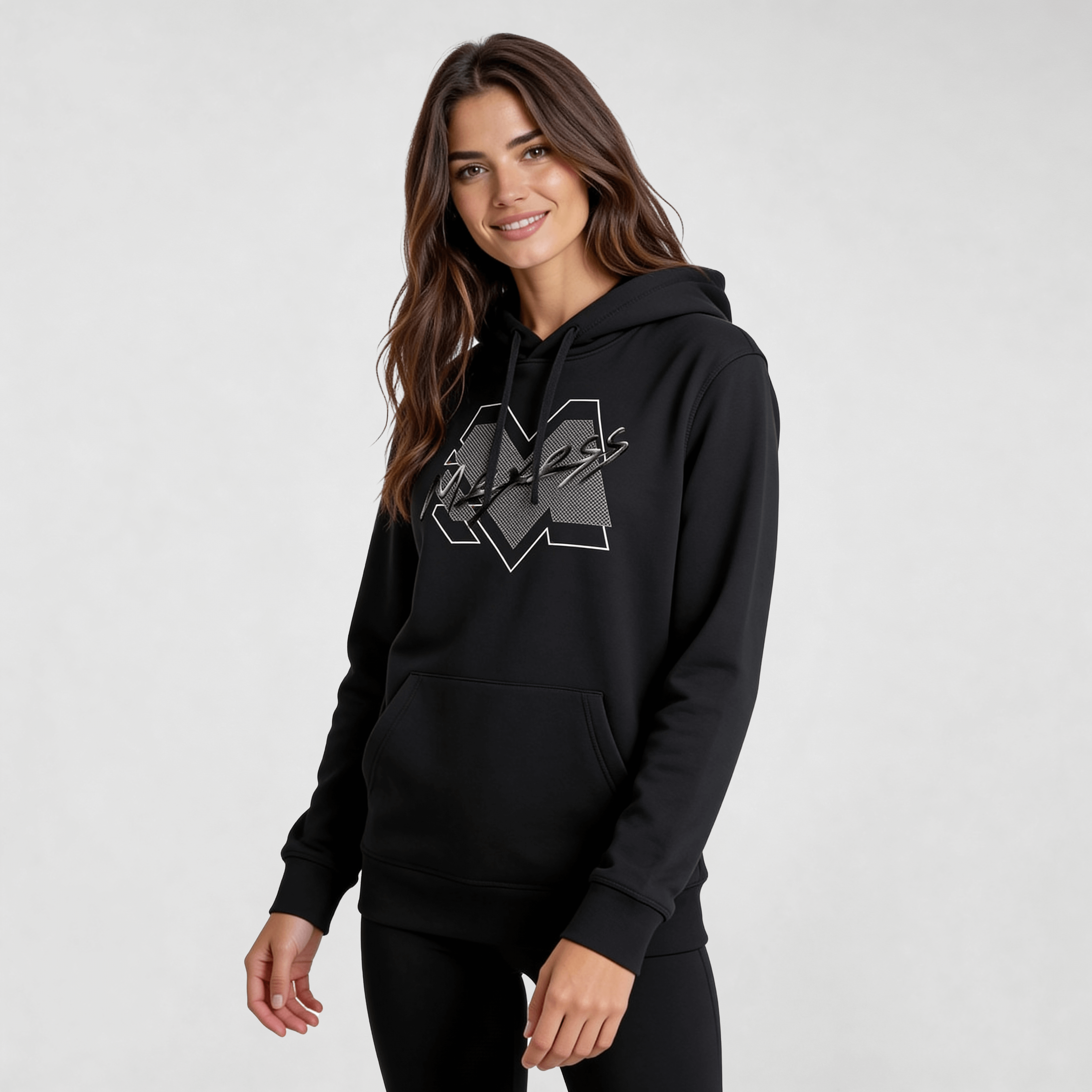 Woman wearing black streetwear hoodie with minimalist logo, showcasing modern urban style and comfort by MEXESS.