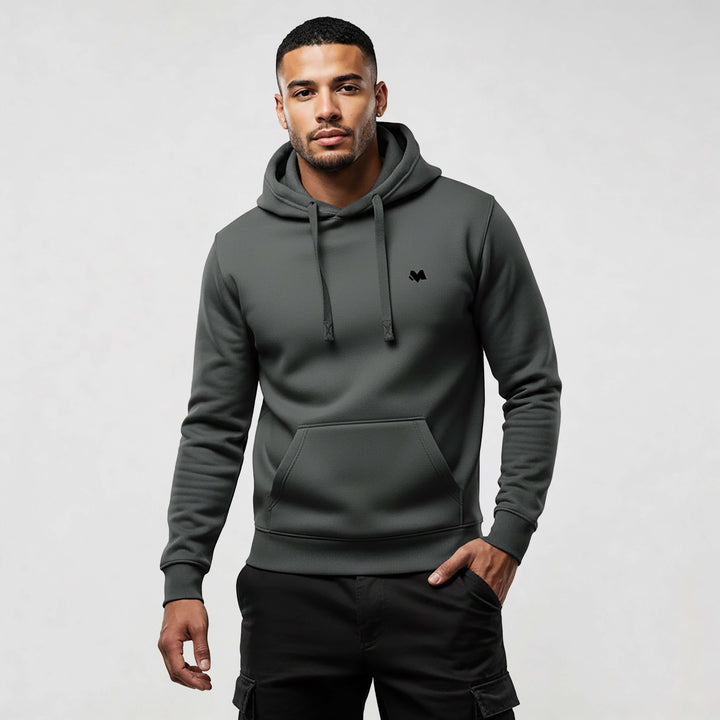 Man wearing MEXESS Organic Cotton streetwear hoodie in dark grey with modern design.