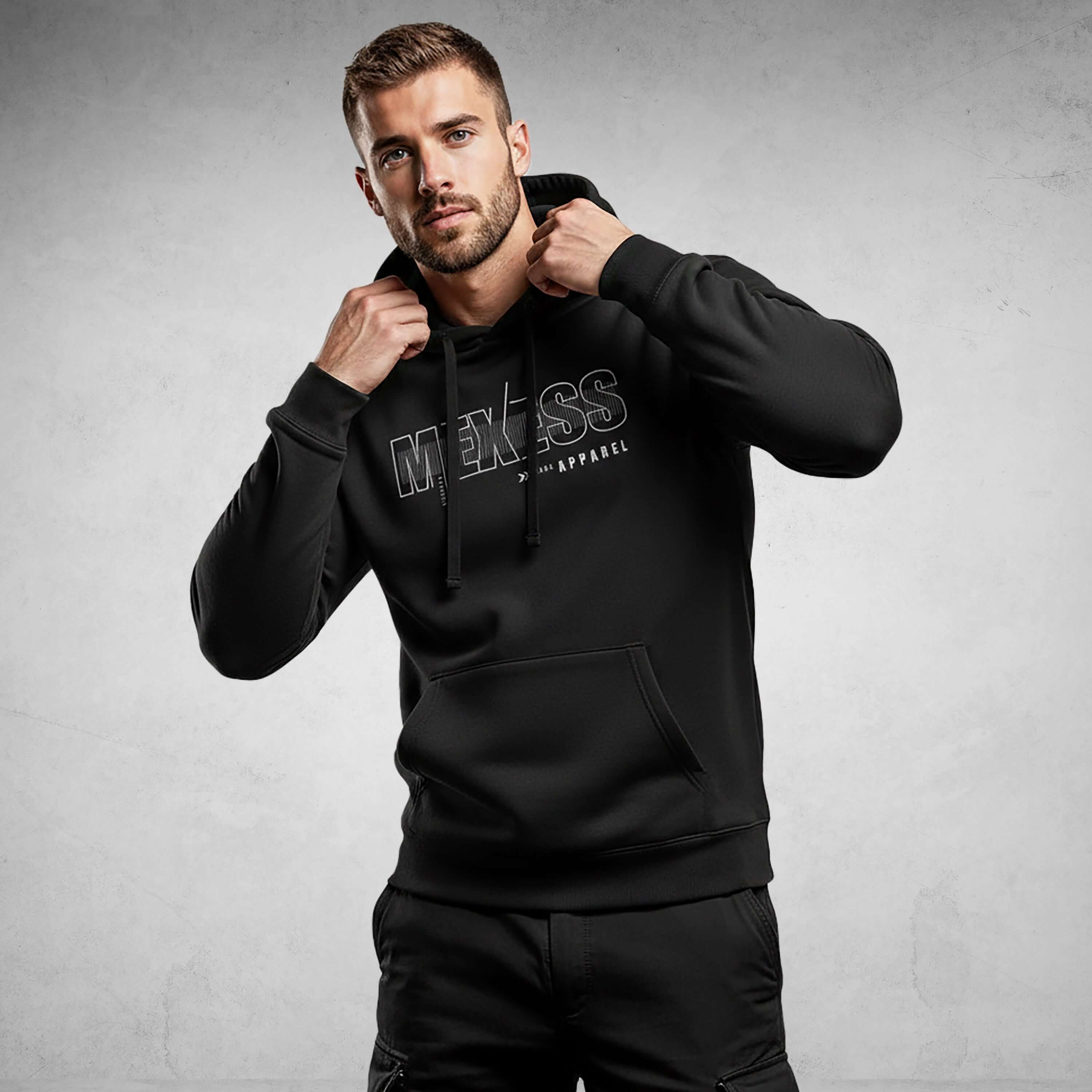 Man wearing MEXESS Iconic Streetwear Hoodie DR710, black, organic cotton, premium minimalist design, versatile men's streetwear hoodie.