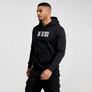 Model wearing black streetwear hoodie DR720 by MEXESS, showcasing modern style, comfort, and quality for men's contemporary fashion.