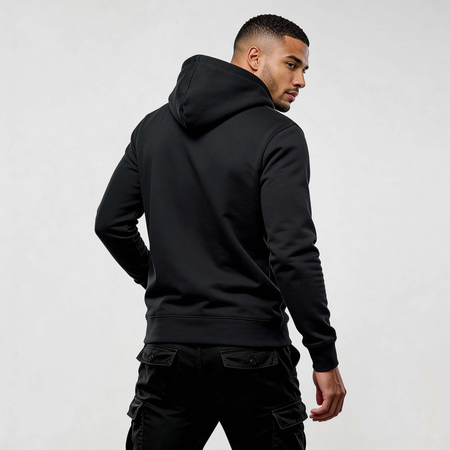 Man wearing a black Iconic Streetwear Hoodie DR720, showcasing contemporary streetwear style.