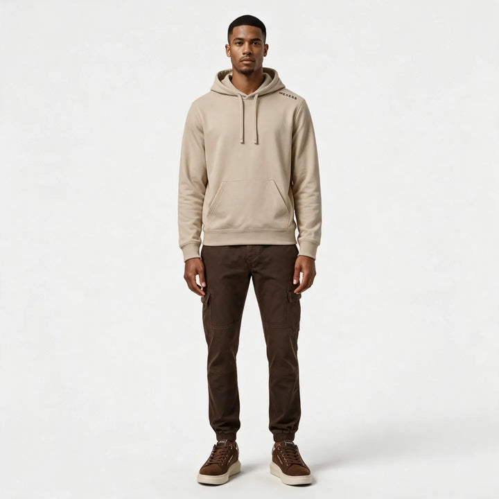 Full-length front view of the beige hoodie worn with dark brown cargo pants