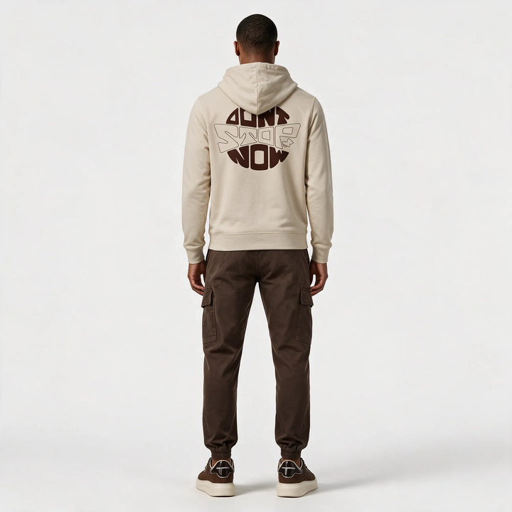 Full-length back view of the beige hoodie with the round DON&