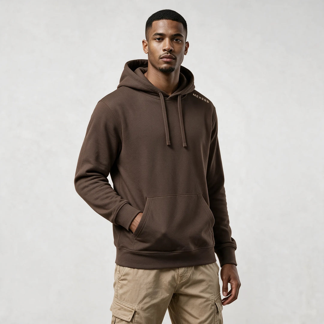 Front view of the mocha organic cotton hoodie with a hand in the kangaroo pocket