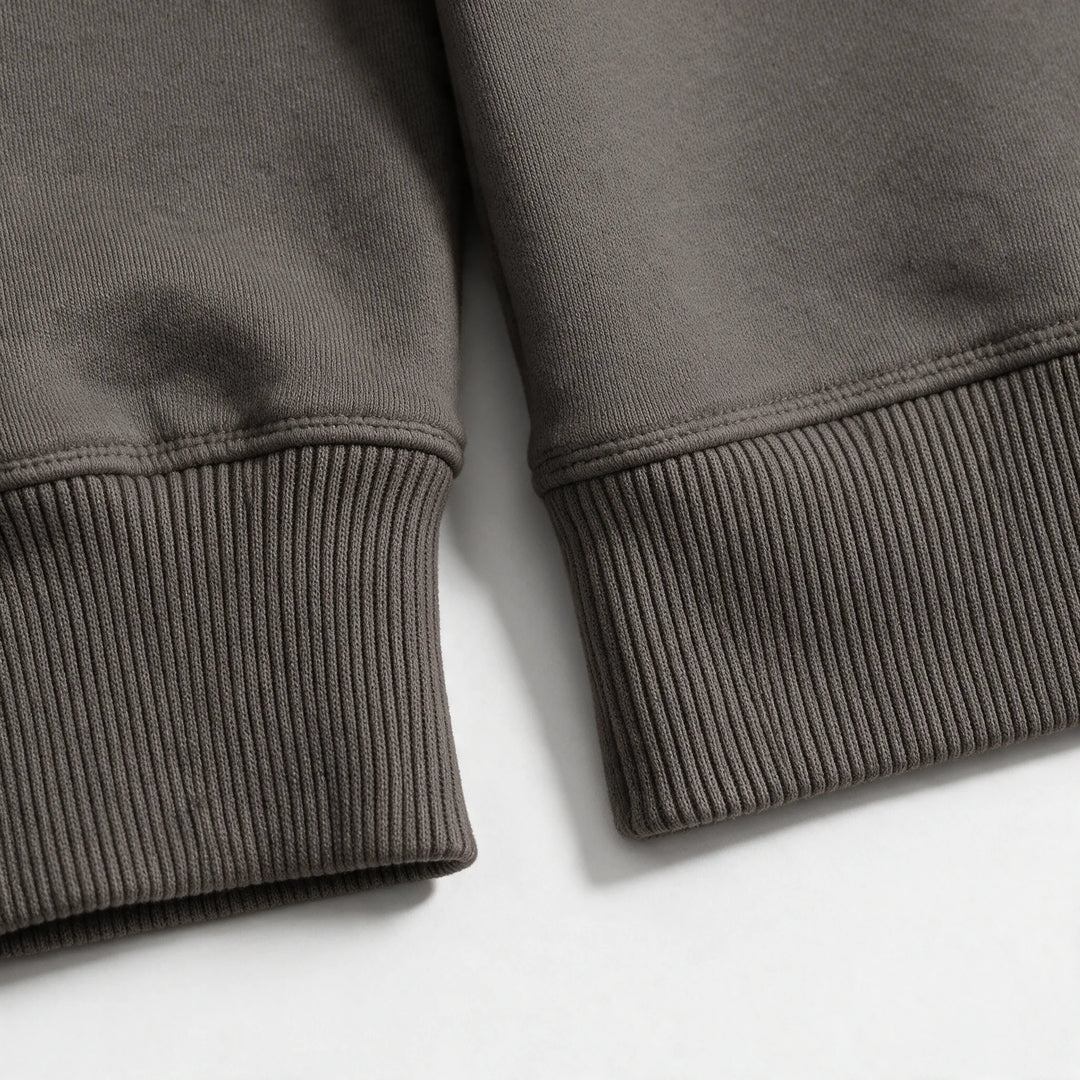 Close-up of the ribbed cuff and hem of the mocha organic cotton hoodie
