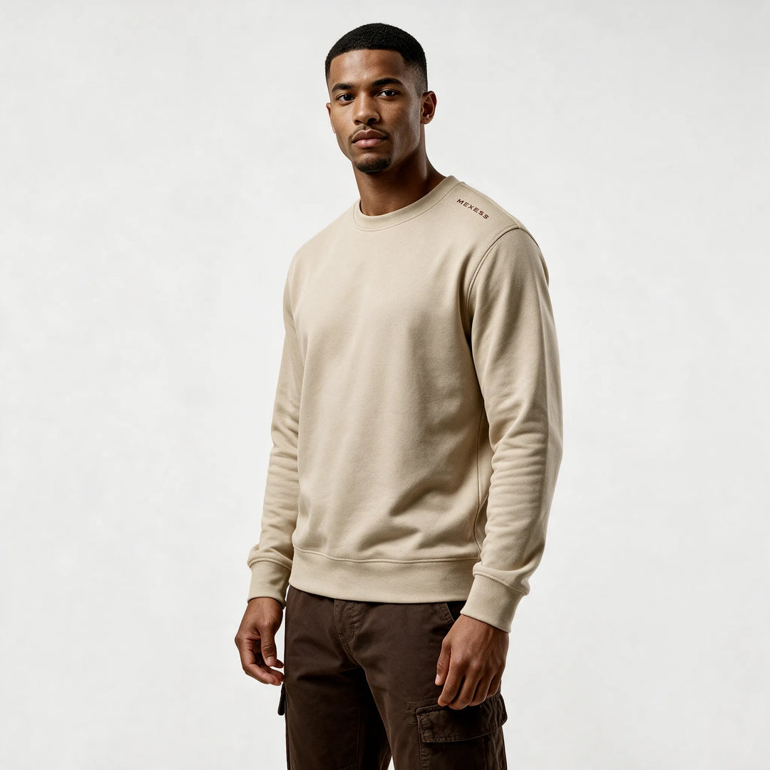 Front three-quarter view of the beige sweatshirt with a small MEXESS mark on the shoulder