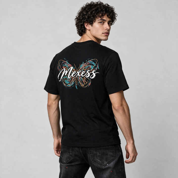 Three-quarter back view of the black t-shirt with the white brush script word Mexess