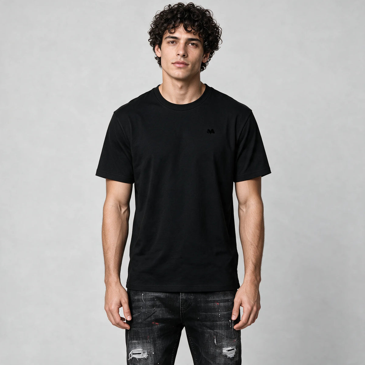 Front of the black crew neck t-shirt with a small tonal M logo on the left chest