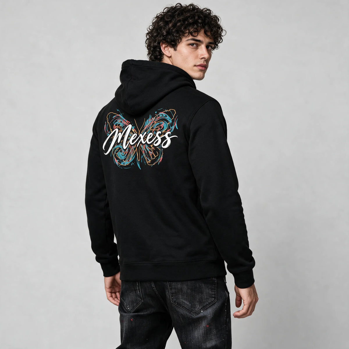 Side-back view of the black hoodie with the teal and orange butterfly print on the upper back