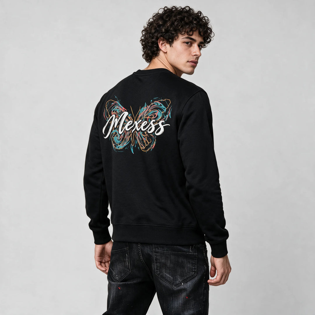 Back of the black sweatshirt with the white brush script word Mexess over the butterfly