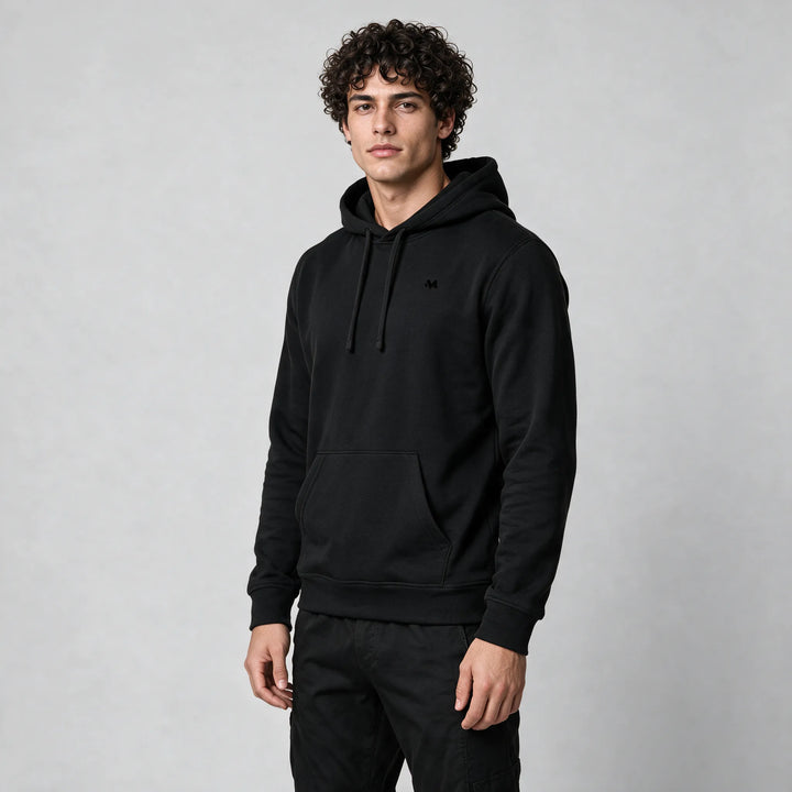 Front view of the black organic cotton hoodie with a small tonal chest logo