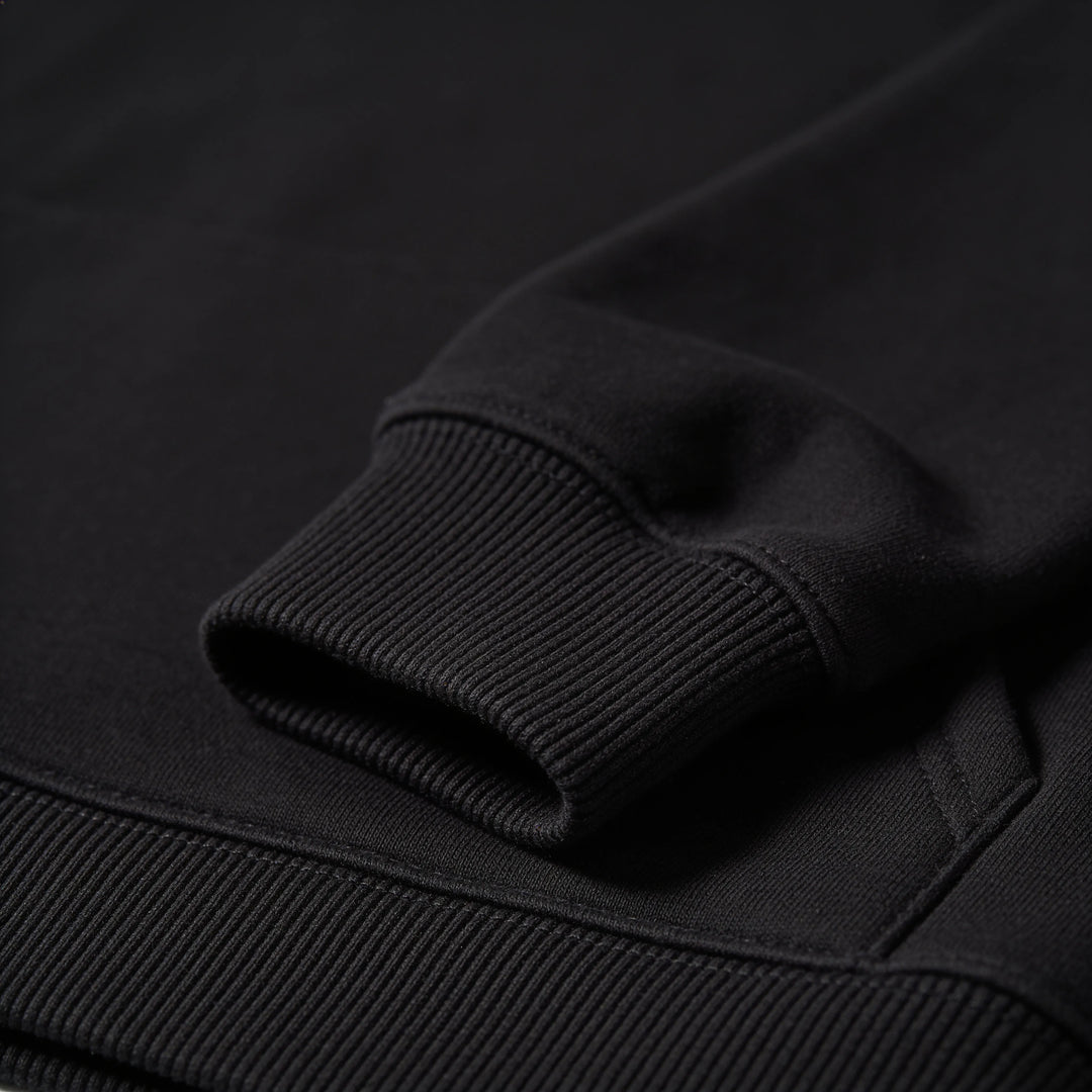 Close-up of the ribbed cuff on the black hoodie