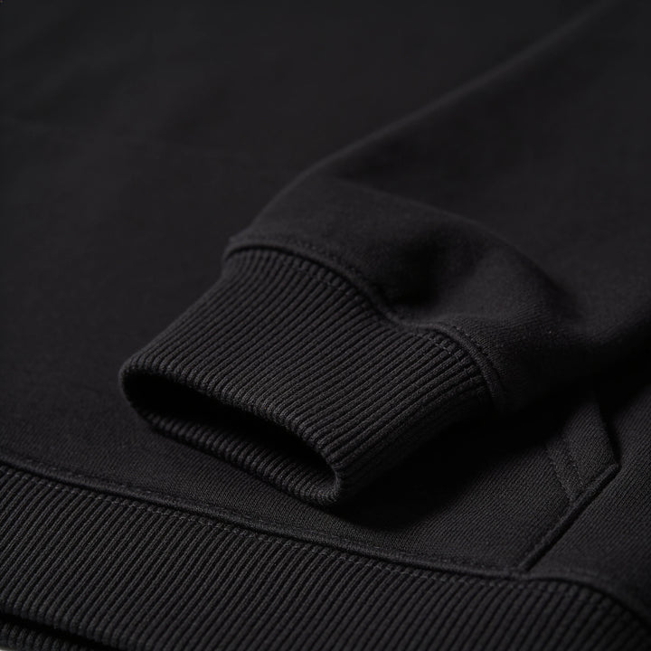 Close-up of the ribbed cuff on the black hoodie