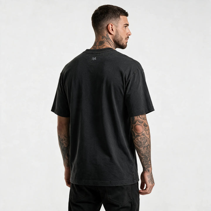 Back view of the washed black t-shirt with a small M logo below the collar