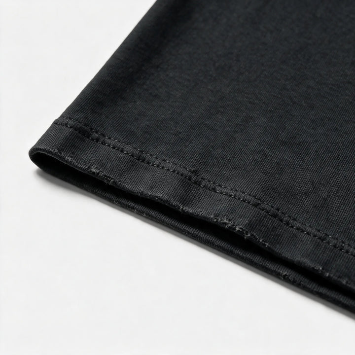 Close-up of the sleeve hem showing the garment dyed finish in washed black