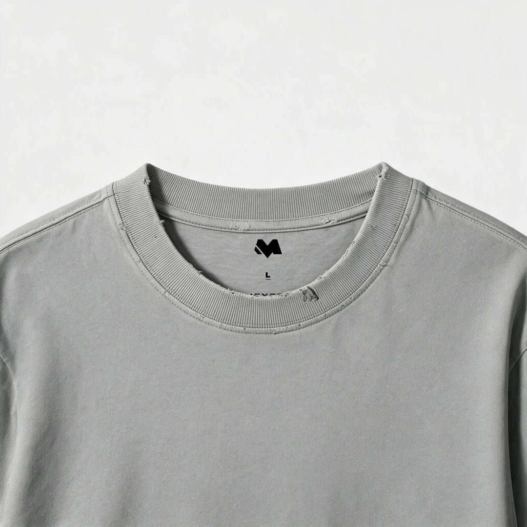 Close-up of the ribbed crew neck and printed label of the gray t-shirt