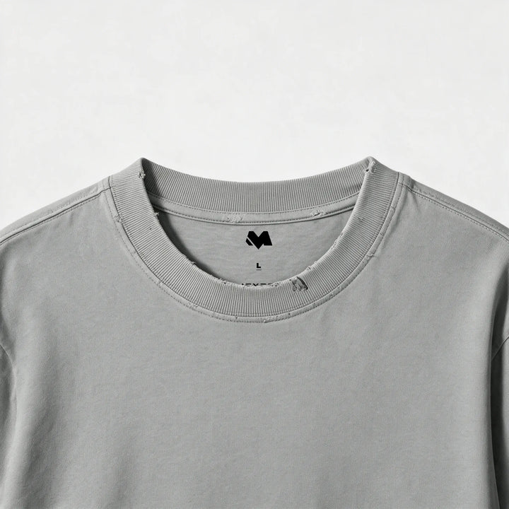 Close-up of the ribbed crew neck and printed label of the gray t-shirt