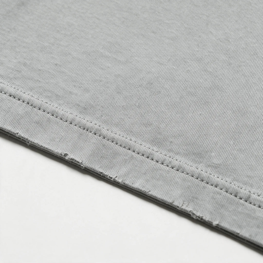 Close-up of the fabric and stitching of the gray garment dyed t-shirt