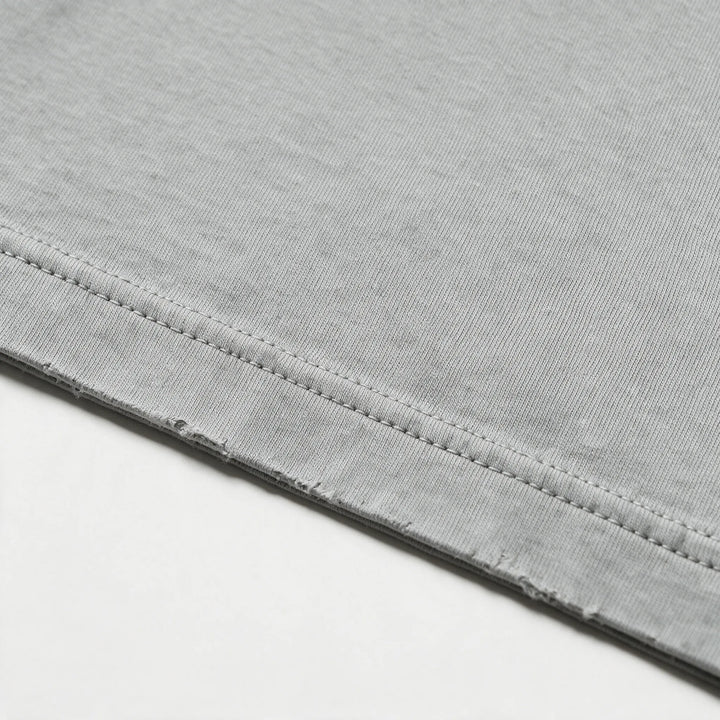 Close-up of the fabric and stitching of the gray garment dyed t-shirt