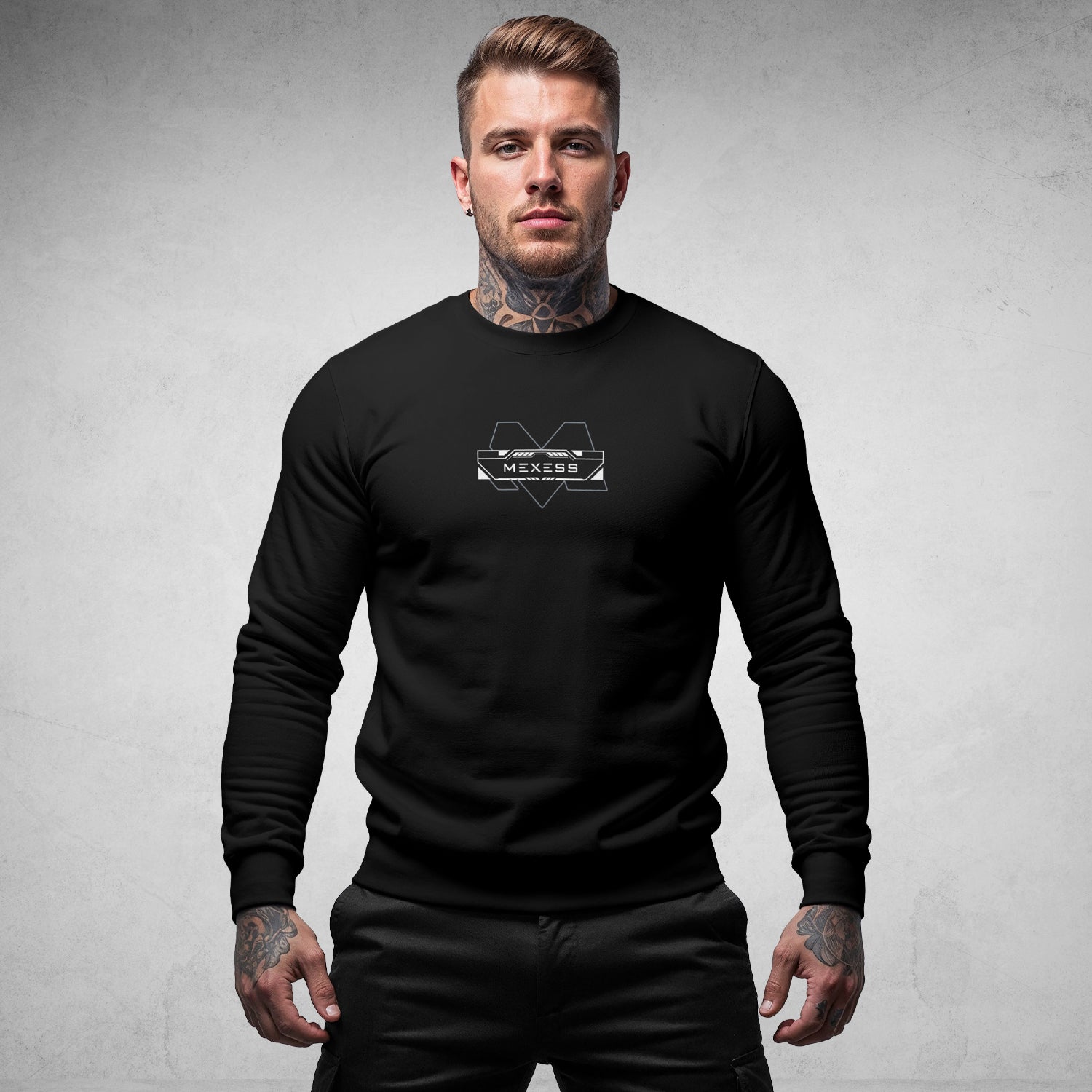 MEXESS black organic cotton sweatshirt worn by tattooed male model against gray background