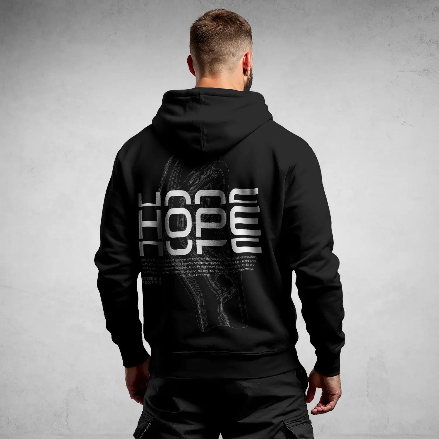 Man wearing Iconic Streetwear Hoodie DR697 with bold graphic text on the back, blending modern urban style and comfort.