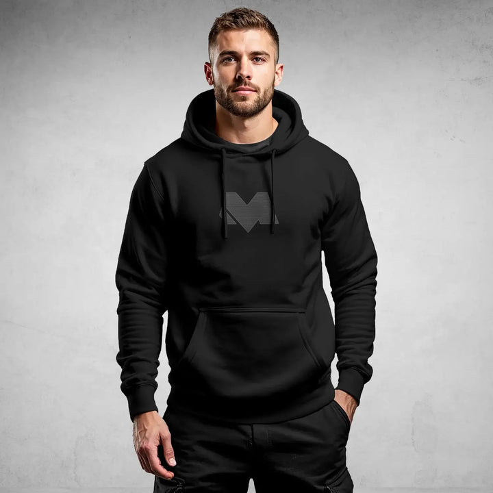 Model wearing iconic black streetwear hoodie DR697 with minimal logo, showcasing urban and modern style by MEXESS.